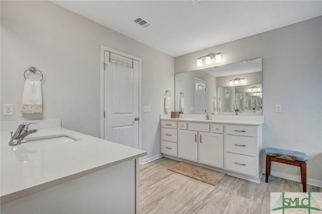 bathroom featuring vanity and wood-type flooring