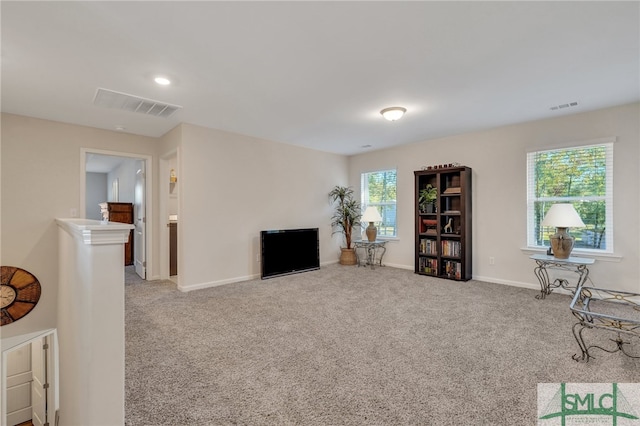 living area featuring carpet