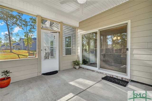 unfurnished sunroom featuring ceiling fan