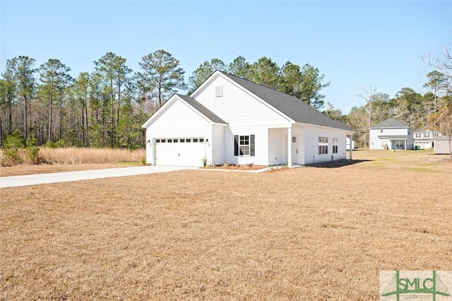 view of front of property with a garage, driveway, and a front yard