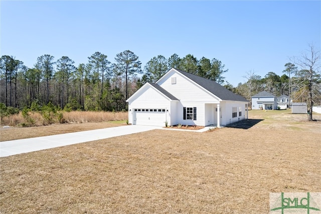 view of front of house featuring a garage, a front lawn, and concrete driveway