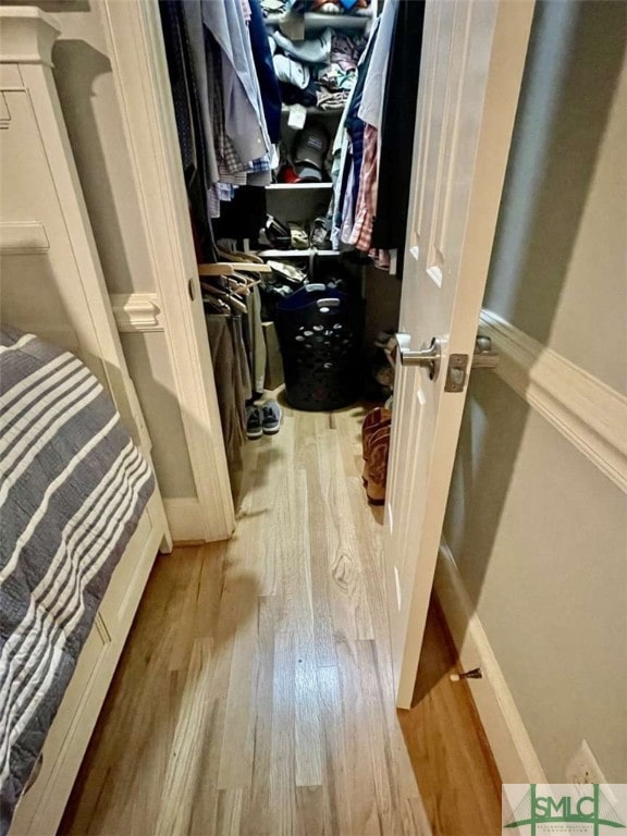 walk in closet featuring light hardwood / wood-style flooring