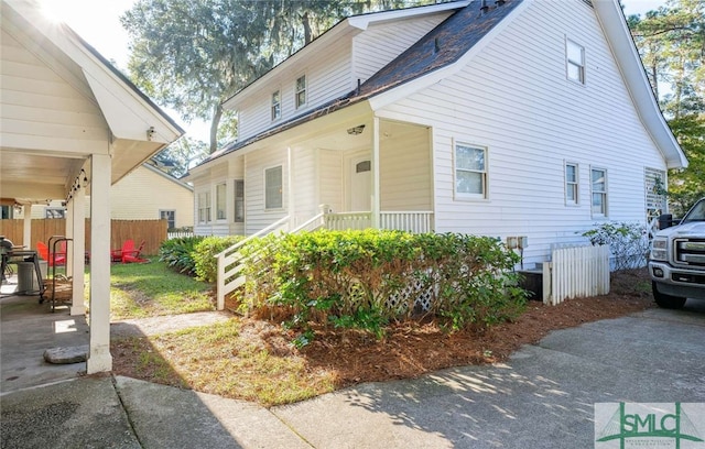 view of side of property featuring a porch