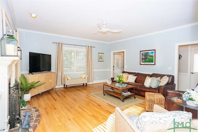 living room with hardwood / wood-style flooring, ceiling fan, and ornamental molding