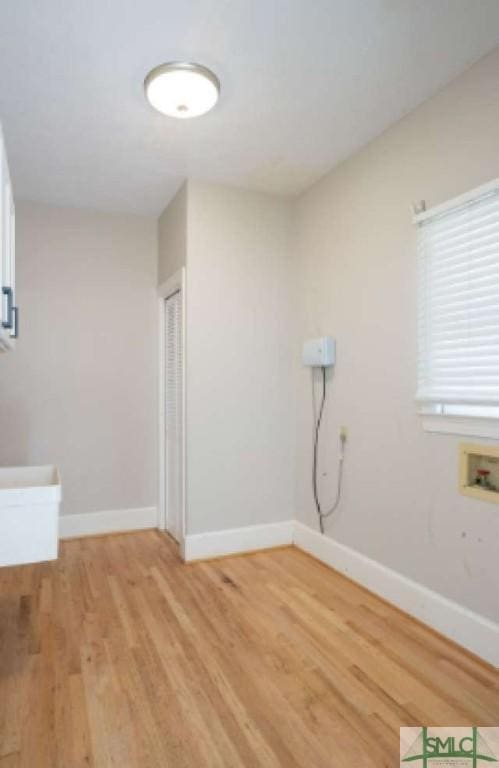 unfurnished room with baseboards and light wood finished floors