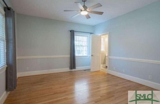 spare room with a ceiling fan, baseboards, and wood finished floors