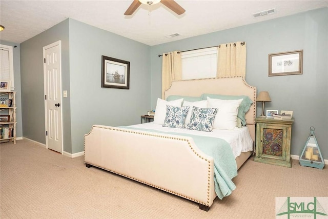 carpeted bedroom featuring baseboards, a ceiling fan, and visible vents