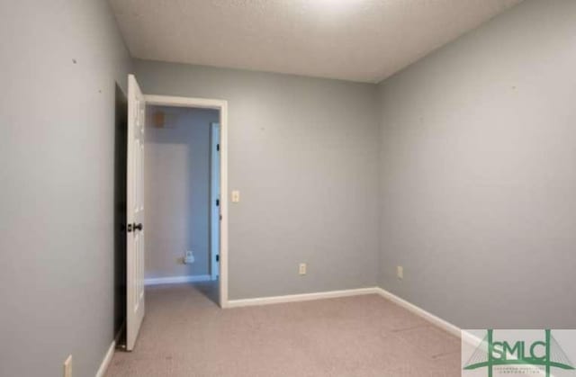 interior space featuring baseboards and light carpet