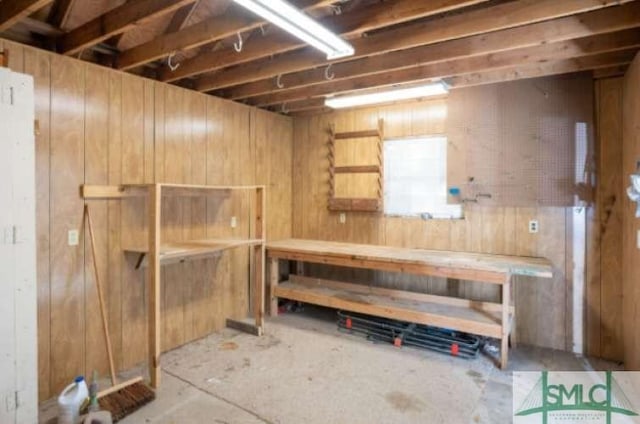 basement featuring wooden walls