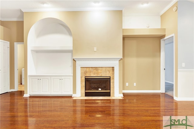 unfurnished living room with crown molding, a fireplace, and wood-type flooring