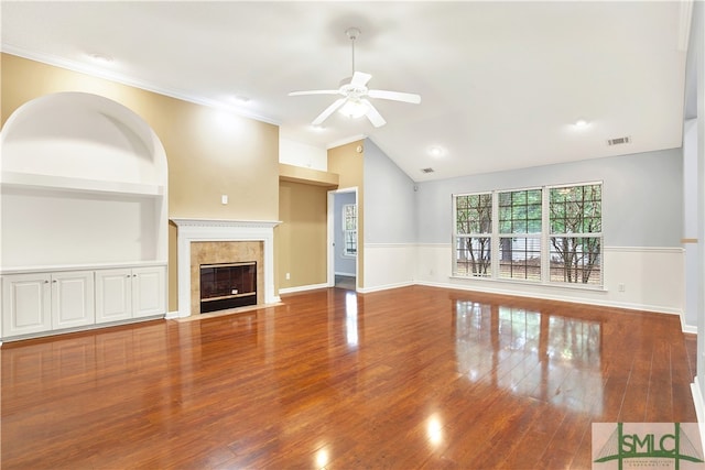 unfurnished living room with lofted ceiling, ornamental molding, hardwood / wood-style flooring, and ceiling fan