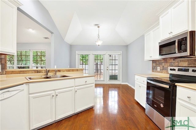 kitchen with appliances with stainless steel finishes, sink, lofted ceiling, decorative light fixtures, and dark wood-type flooring