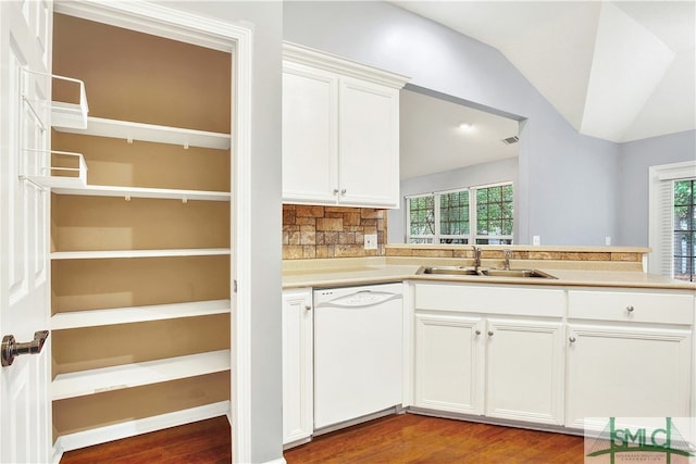 kitchen featuring white dishwasher, sink, hardwood / wood-style floors, vaulted ceiling, and white cabinetry