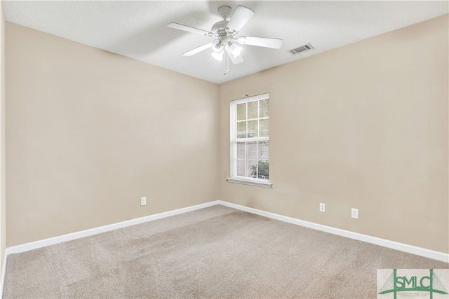 empty room featuring ceiling fan, carpet flooring, and a textured ceiling