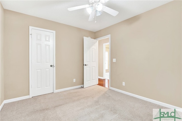 unfurnished bedroom with light carpet and ceiling fan