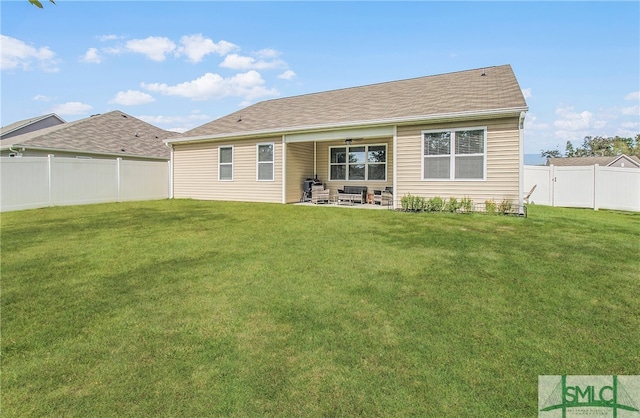 rear view of house featuring a yard and a patio area