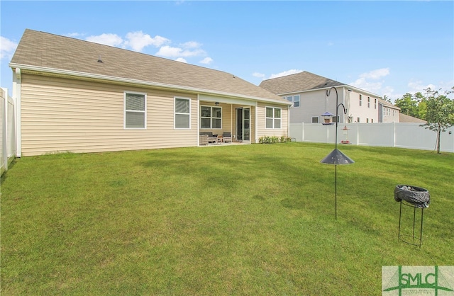 rear view of property featuring a patio area and a lawn