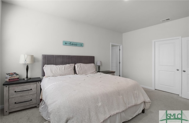 bedroom with light colored carpet