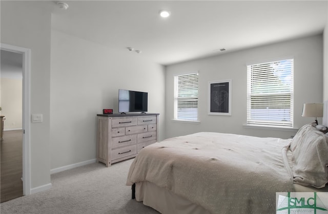 bedroom with light colored carpet