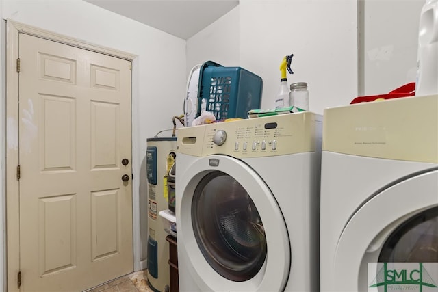 laundry room with electric water heater and washer and clothes dryer