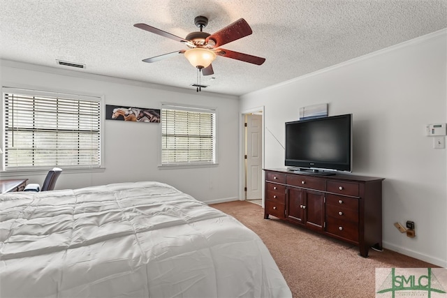 carpeted bedroom featuring ceiling fan, crown molding, and a textured ceiling