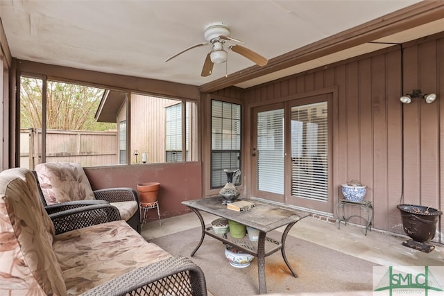 sunroom featuring ceiling fan and a wealth of natural light