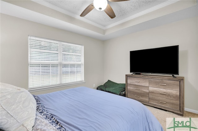 carpeted bedroom featuring a raised ceiling, a textured ceiling, and ceiling fan