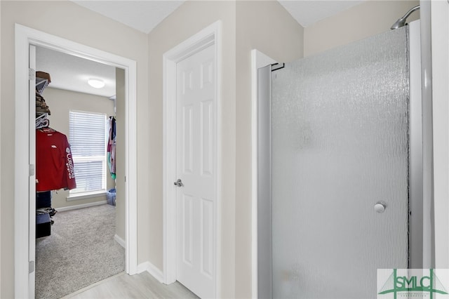 bathroom featuring hardwood / wood-style floors and a shower