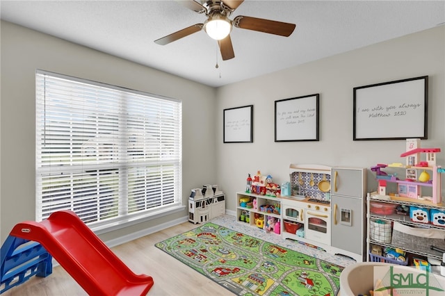 recreation room featuring ceiling fan and wood-type flooring