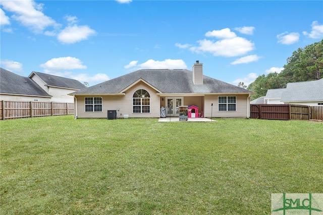 rear view of property with a yard, a patio area, and central air condition unit