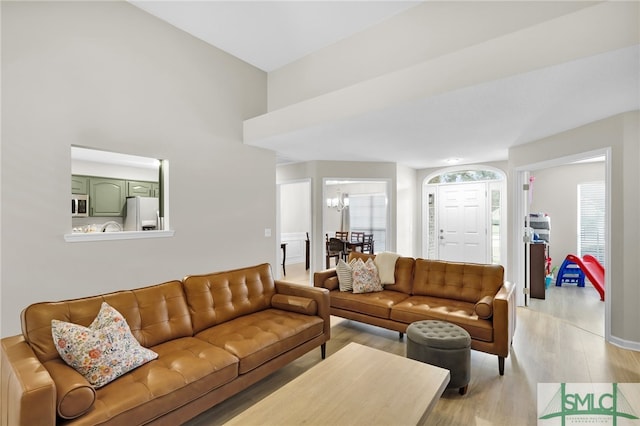 living room featuring light hardwood / wood-style floors and a chandelier