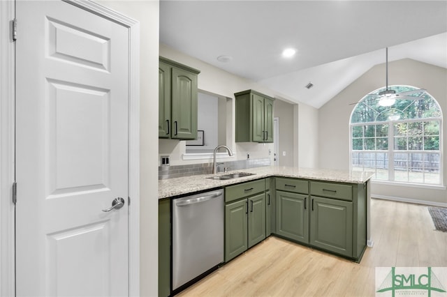 kitchen with lofted ceiling, dishwasher, sink, green cabinetry, and light wood-type flooring