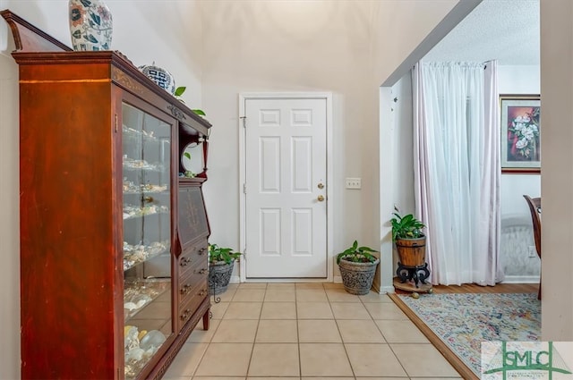 foyer entrance featuring light tile patterned floors