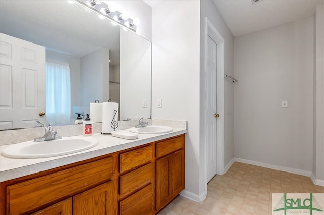 bathroom featuring vanity and a textured ceiling