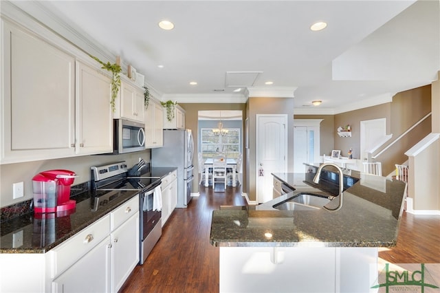 kitchen featuring appliances with stainless steel finishes, sink, a spacious island, white cabinets, and dark wood-type flooring