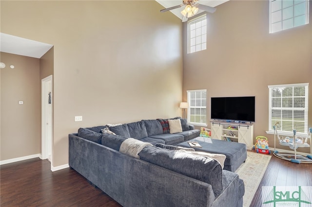 living room featuring a towering ceiling and a wealth of natural light