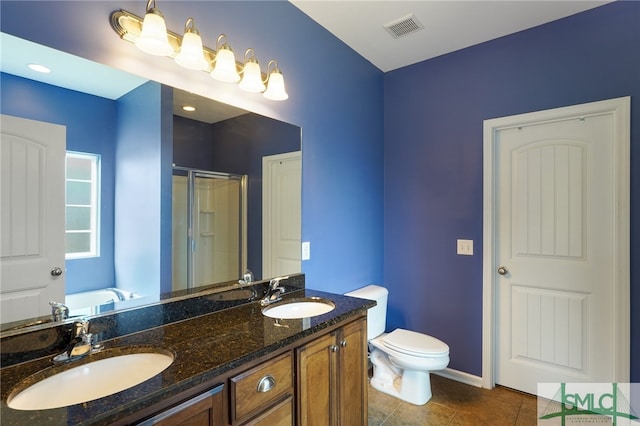 bathroom featuring vanity, tile patterned flooring, toilet, and an enclosed shower