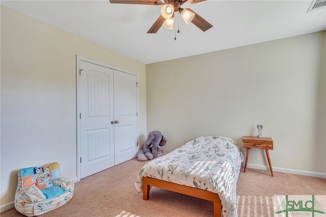 bedroom featuring a closet, ceiling fan, and light colored carpet