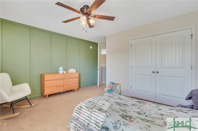 carpeted bedroom featuring a closet and ceiling fan