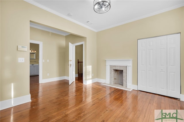 unfurnished living room with hardwood / wood-style flooring and ornamental molding