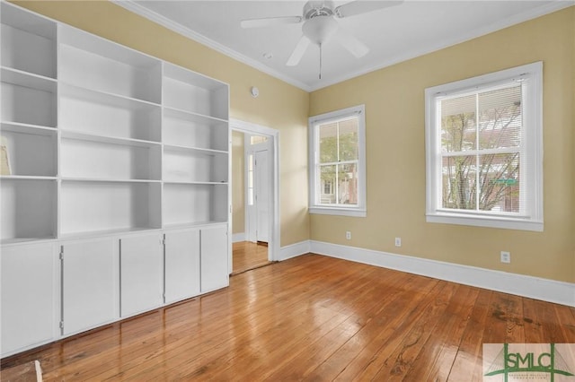 124 Brady St, Savannah, GA 31401 - unfurnished bedroom with baseboards, hardwood / wood-style flooring, ornamental molding, and a ceiling fan