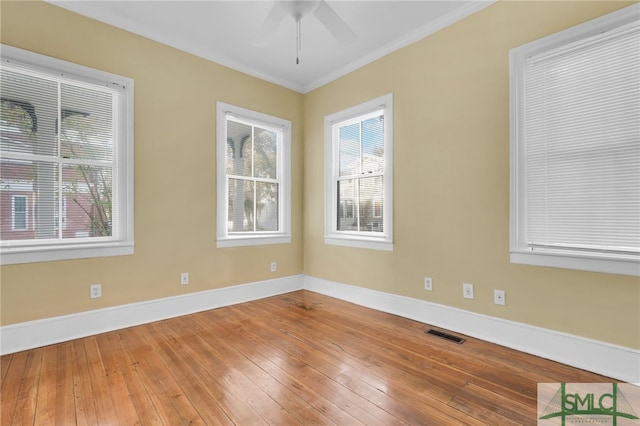 unfurnished room with ceiling fan, wood-type flooring, and ornamental molding