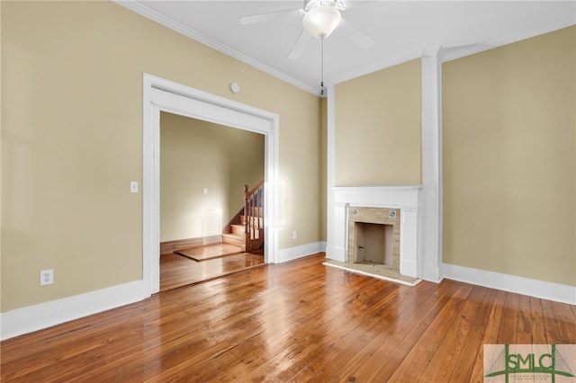 unfurnished living room featuring ornamental molding, wood-type flooring, and ceiling fan