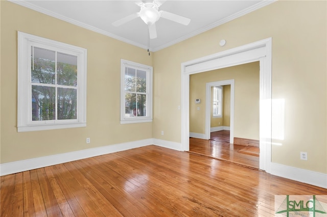 empty room with ceiling fan, a healthy amount of sunlight, light hardwood / wood-style flooring, and ornamental molding