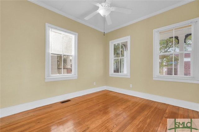 spare room with ceiling fan, hardwood / wood-style flooring, a healthy amount of sunlight, and crown molding