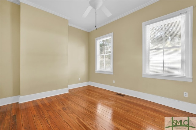 spare room featuring ornamental molding, wood-type flooring, and ceiling fan