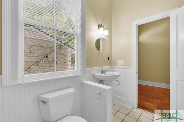 bathroom with hardwood / wood-style floors, sink, and toilet