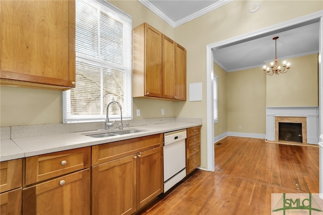 kitchen with light hardwood / wood-style floors, sink, ornamental molding, decorative light fixtures, and dishwasher