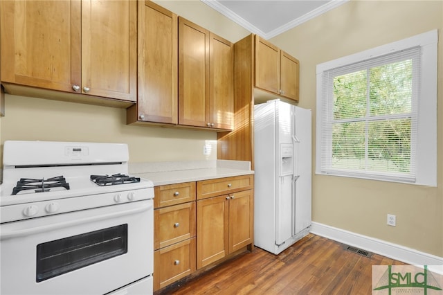 kitchen featuring white appliances, dark hardwood / wood-style floors, and crown molding