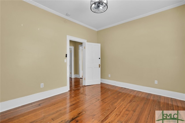 unfurnished room featuring hardwood / wood-style floors and crown molding